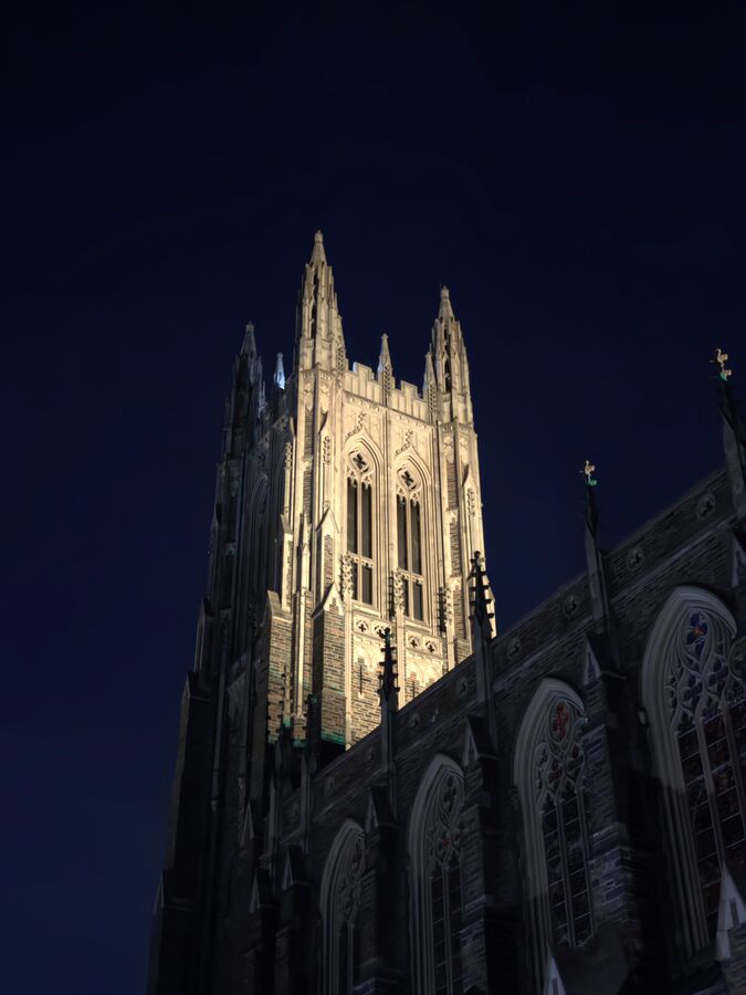 Duke Chapel tower against a deep blue evening sky